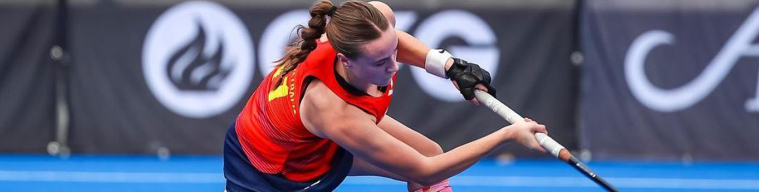 Lucy Sharman goes for a goal with a hockey stick in her hands