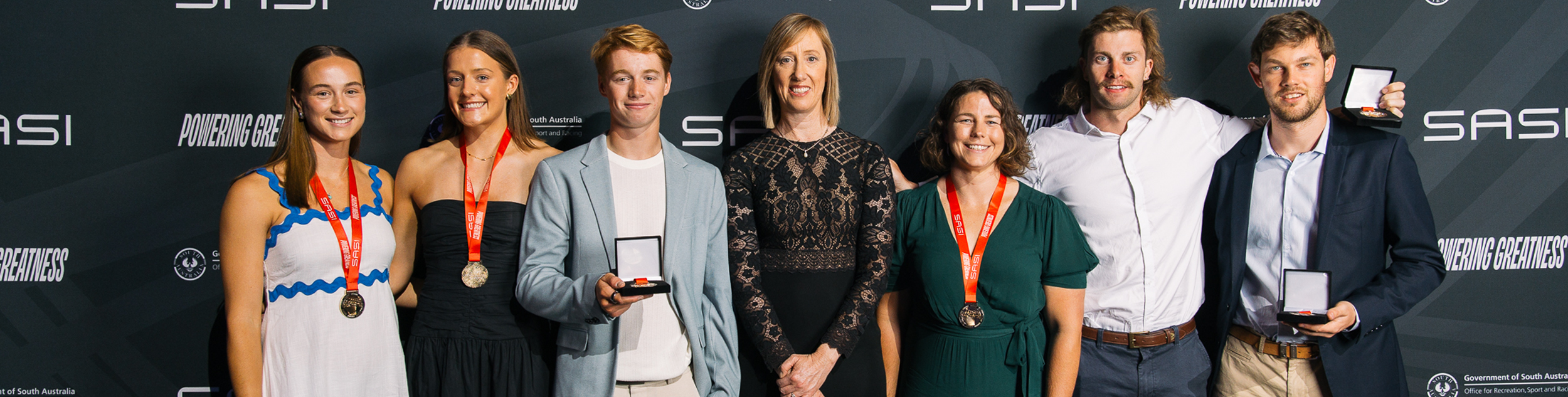 Award recipients standing with their medals
