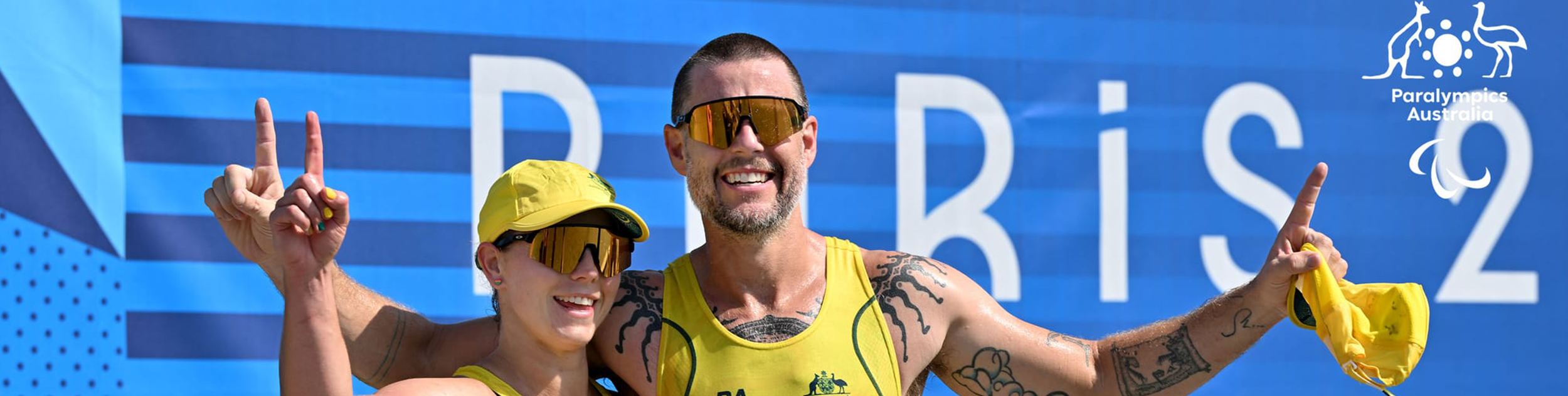 Jed Altschwager and Nikki Ayers smiling with their hands in the air