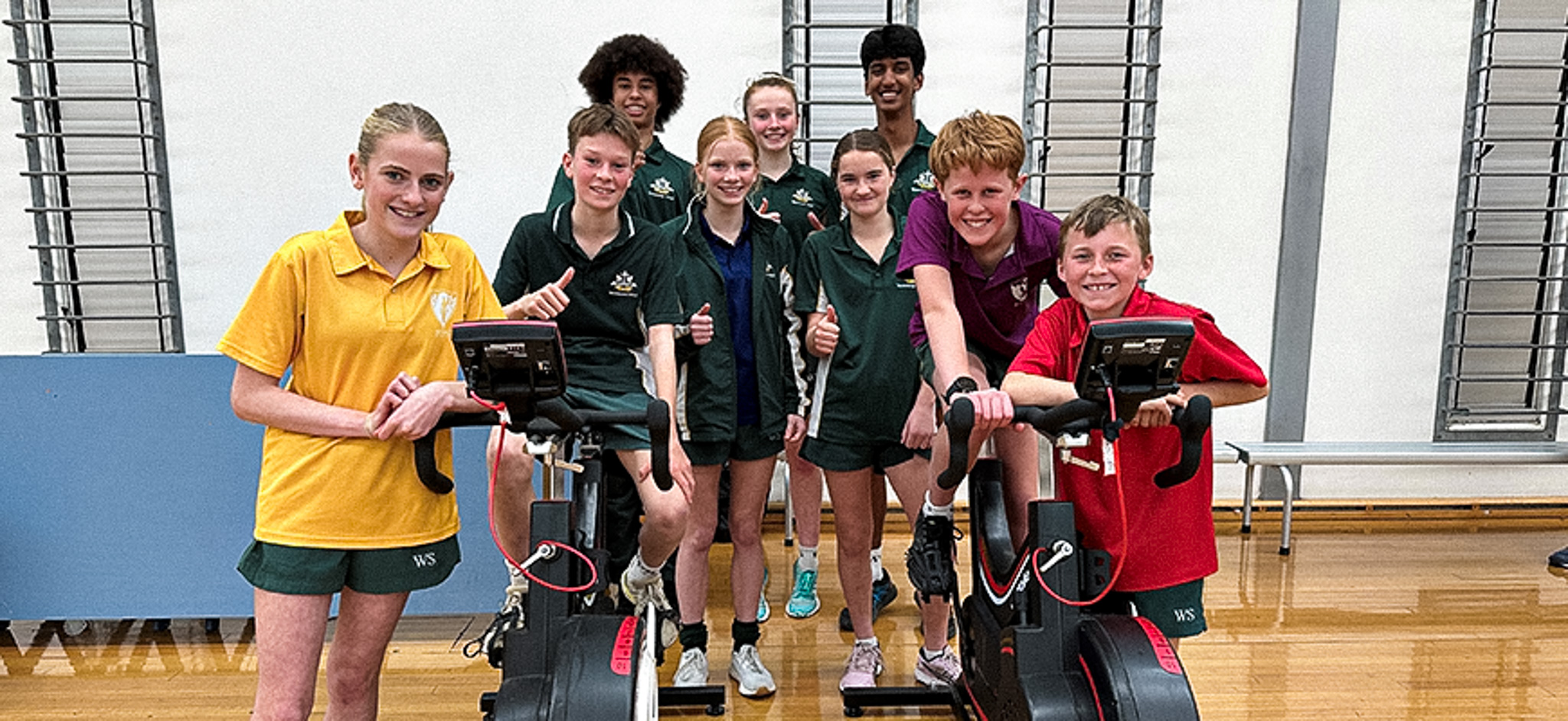 Students sitting on a bike doing talent search