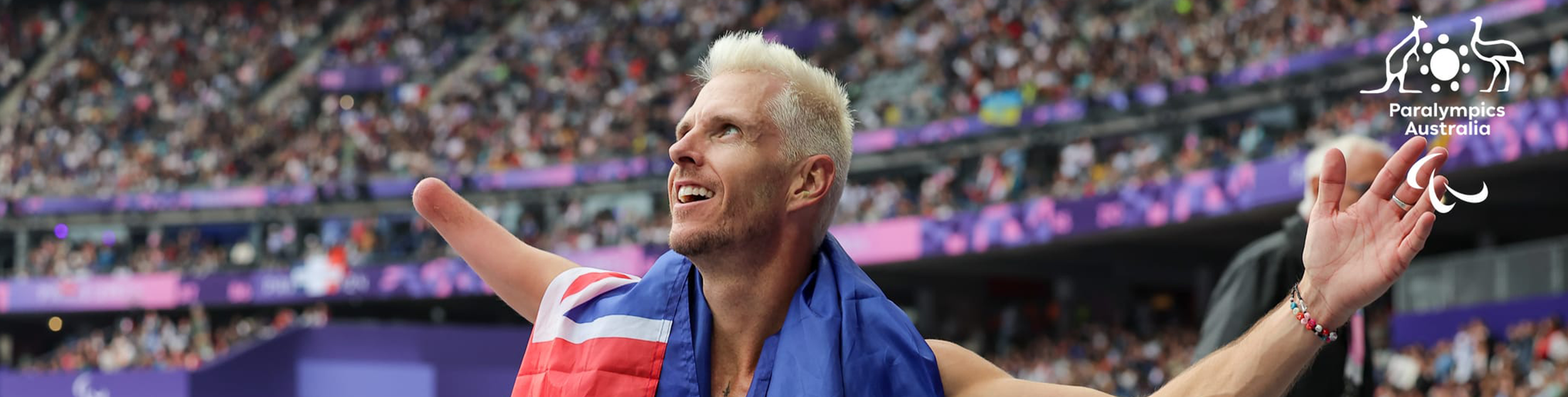 Michael Roeger looks up to the crowd with an Australian flag around his neck